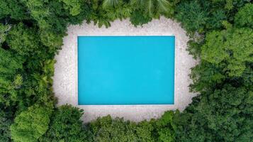 An aerial view of a swimming pool surrounded by trees photo