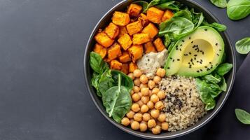 A bowl of food with vegetables, chickpeas and avocado photo
