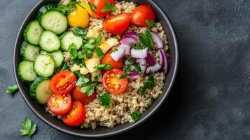 Quinoa salad with vegetables and cucumbers photo
