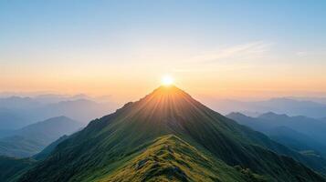 breathtaking view of mountain peak illuminated by rising sun, surrounded by rolling hills photo