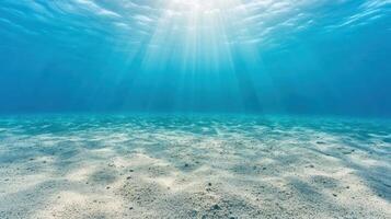 serene underwater landscape featuring sandy bottom and sunlight rays filtering through water photo