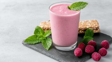 Creamy smoothie with raspberries and energy bar on slate surface, evoking freshness and health photo