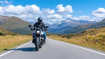 motorcyclist rides through scenic mountain road, surrounded by stunning landscapes and blue photo