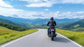 motorcyclist rides along winding road through lush green mountains, enjoying scenic view photo