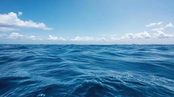 Blue ocean water with clouds and sky background photo