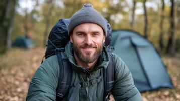 A man with a beard and backpack in the woods photo