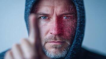 A man in a hoodie is pointing his finger up photo