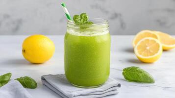 A green smoothie with lemon and mint leaves photo