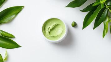 Green face mask with leaves on white background top view photo
