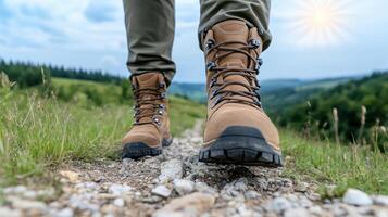 A person wearing hiking boots walking on a trail photo