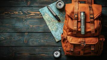 rugged backpack sits on wooden surface alongside map, flashlight, and compass, perfect for camping adventures. This setup inspires exploration and outdoor excitement photo