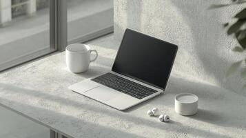 Laptop on a table with coffee and mug photo