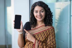 Business Woman Pointing Finger At Mobile Phone photo