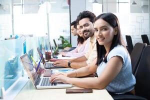 Team Of Online Traders Working Together On Laptops photo