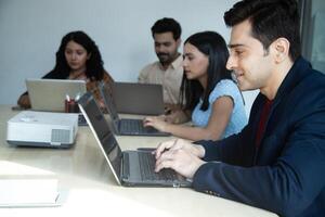 Group Of Employees Are Working On Laptop photo