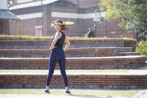 Active Woman Doing Yoga Exercise And Looking Back Into The Camera photo