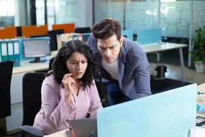 Confused People In Front Of Laptop With Surprised Facial Expressions photo