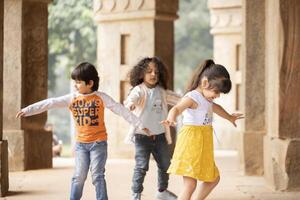 Nice Children Playing And Having Fun While Spreading Their Hands Apart photo