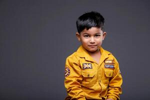A Cute Kid Posing In Front Of The Camera photo