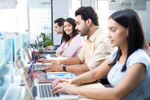 Multinational Team In Office Female Smiling While Looking At Camera photo