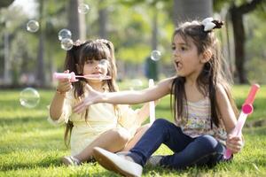 Bubble Blowing Girls Enjoying In The Park photo