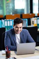 Professional Man Looking At Laptop With Positive Smile Reading Email photo