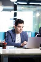 Office Director Sitting At Workplace Desk Looking At Laptop With Shocked Face Expression photo
