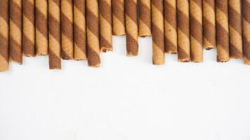Crunchy wafer rolls with a chocolate swirl isolated on white background photo