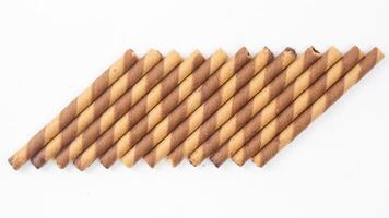 Chocolate flavored wafer rolls with a delicate crunch isolated on white background photo