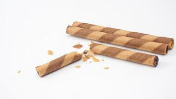 Chocolate coated wafer rolls with a crispy crunch isolated on white background photo