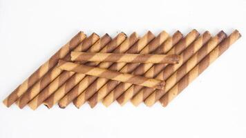 Gourmet chocolate wafer rolls with swirled layers isolated on white background photo
