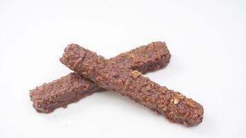 Delicious chocolate coated wafer bars with crunchy layers and caramel filling isolated on white background photo
