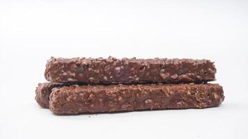 Chocolate covered wafer bars featuring crispy layers caramel and rice crisps isolated on white background photo