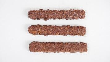Rich chocolate coated wafer bars with layers of caramel and crispy wafers isolated on white background photo