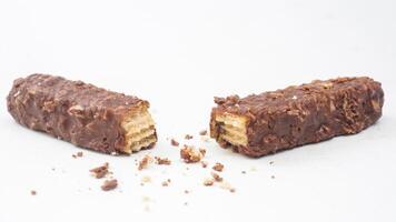 Caramel infused wafer bars with chocolate coating and crispy rice isolated on white background photo