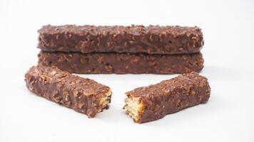 Crispy wafer bars with gooey caramel and chocolate coating isolated on white background photo