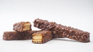 Chocolate caramel wafer bars with crunchy layers and rich coating isolated on white background photo