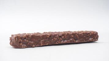Chocolate coated wafer bars with crispy layers caramel and rice crisps isolated on white background photo