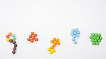 Chocolate coated colorful candies with crunchy and vibrant sugar shell and chocolate center isolated on white background photo