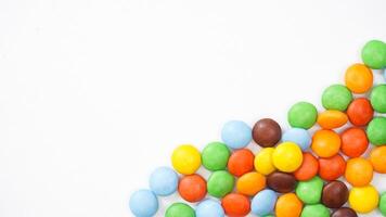 Chocolate coated candies with a crispy sugar shell and rich cocoa core isolated on white background photo