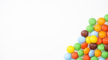 Bright and crunchy sugar shell chocolate candies with a smooth center isolated on white background photo