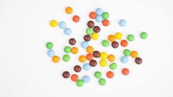 Colorful candy coated chocolates with a crispy outer layer and chocolate core isolated on white background photo