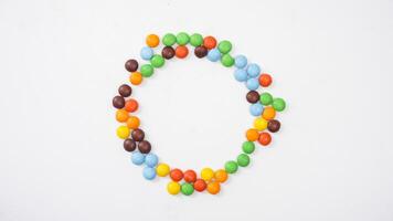 Colorful crispy chocolate candies with a thin sugar shell and chocolate center isolated on white background photo