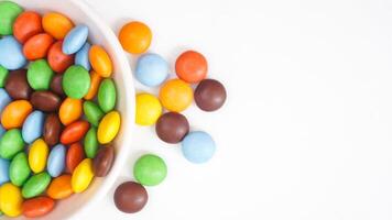 Brightly colored sugar shell chocolates with a creamy chocolate center isolated on white background photo
