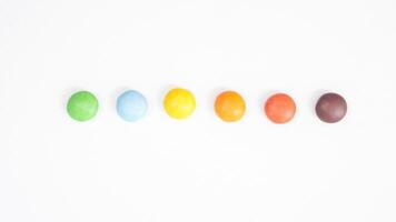Sweet and colorful chocolate candies with a crunchy and thin sugar layer isolated on white background photo