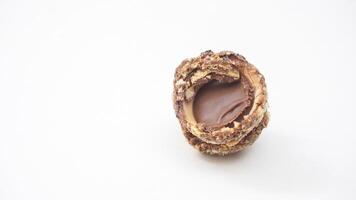 Decadent chocolate truffles coated with nuts and filled with velvety chocolate isolated on white background photo