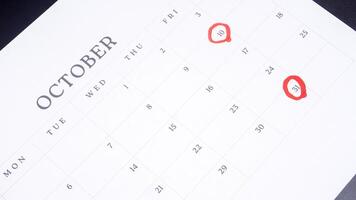 Red circle marked on a calendar at 10 and 31 of October photo