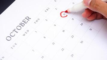 Red circle marked on a calendar at 10 of October as symbol of important day photo
