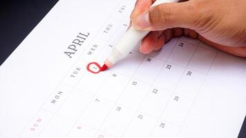 Red circle marked on a calendar at 1 of April as symbol of important day photo