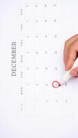 Red circle marked on a calendar at 22 of December as symbol of important day photo
